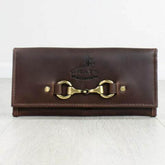 A dark brown leather purse with a metallic snap closure and embossed logo.